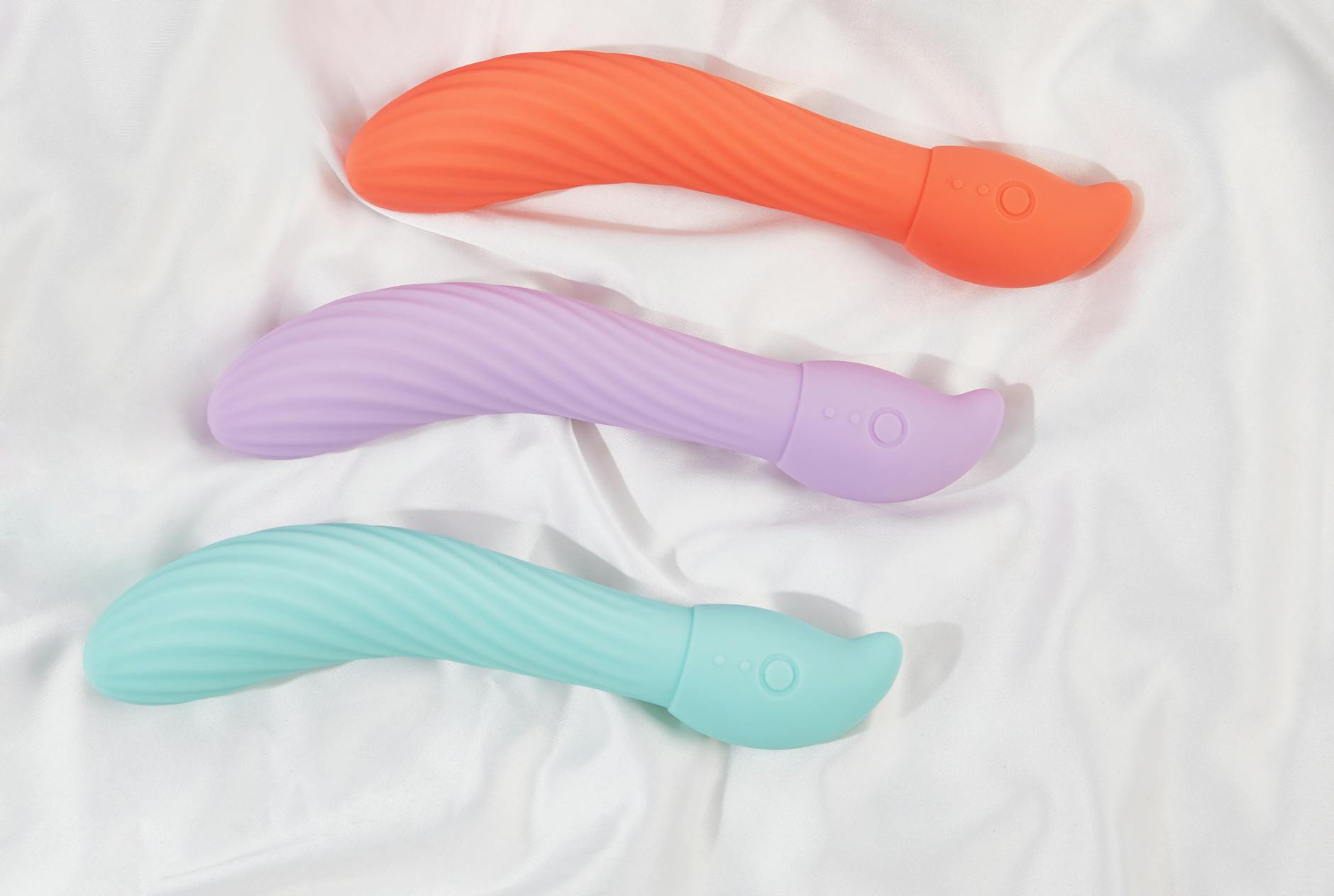 Hand holding a blue silicone lemon vibrator against a purple background, emphasizing sensuality and self-care