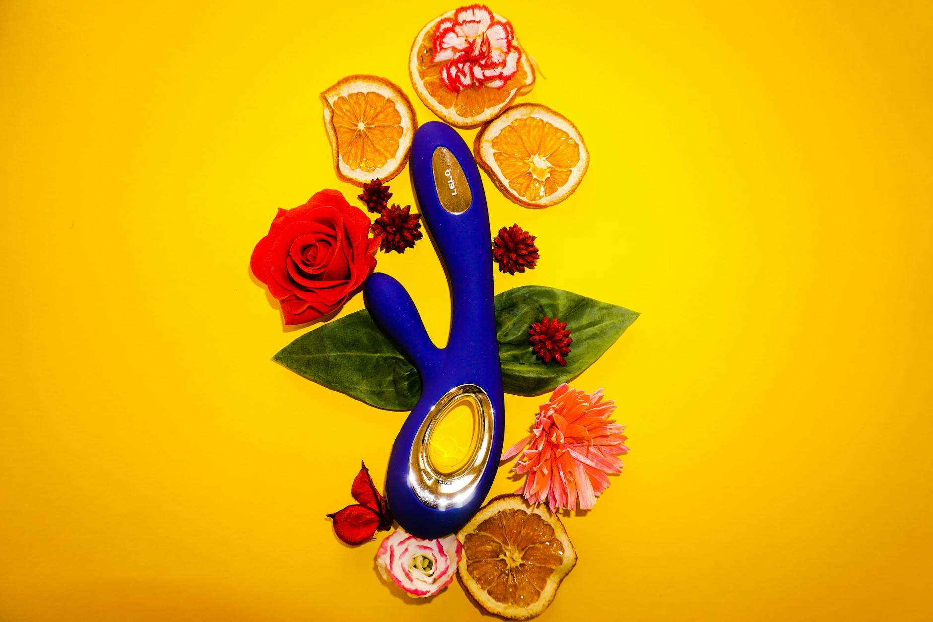 Hands holding a sleek blue clitoral vibrator, symbolizing reconnection and sensual intention